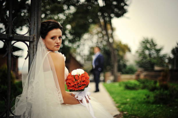 istock Brunette bride with wedding bouquet on hand 670367606