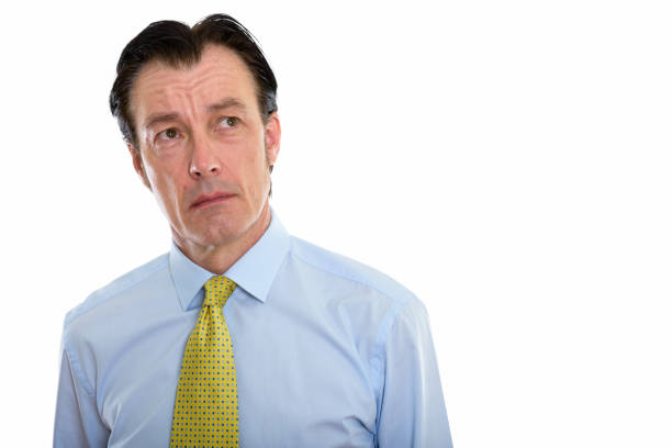 istock Studio shot of mature handsome businessman thinking while looking up 670370208