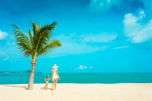 istock Mother and baby on the beach 670381654
