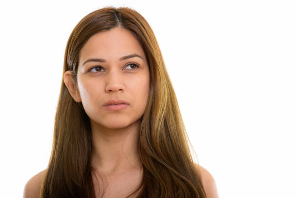 Studio shot of young beautiful woman thinking while looking up horizontal shot