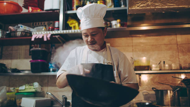 istock Chef preparing food in Chinese restaurant 670381920