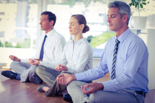 istock Business people doing yoga on floor 670382024