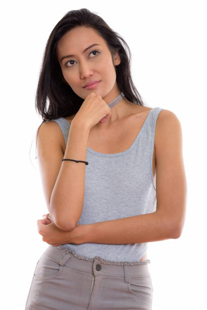 istock Studio shot of young beautiful Asian woman thinking while looking up 670382424