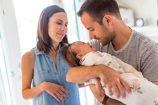 istock Parents hold baby girl, lovingly 670383209