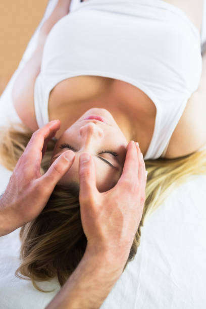 istock Relaxed pregnant woman enjoying reiki technique 670383398