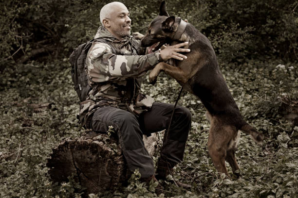 istock Handsome black middle aged man sitting with attack dog 670386154