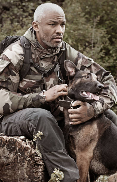 istock Handsome black middle aged man sitting with attack dog 670386186