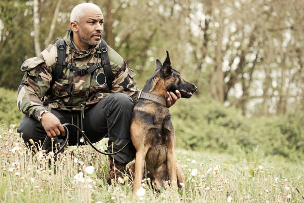 istock Handsome black middle aged man sitting with attack dog 670386416