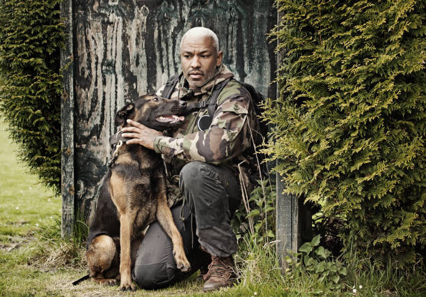 istock Handsome black middle aged man sitting with dog 670387050