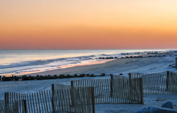 istock beach at ocean at dusk with dune fence 670387472