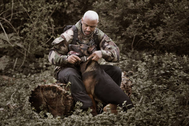 istock Handsome black middle aged man sitting with dog 670387710
