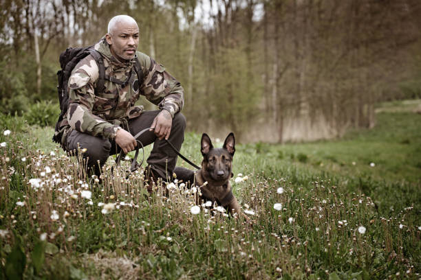 istock Handsome black middle aged man sitting with dog 670387800