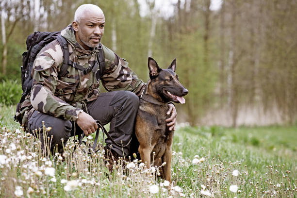 istock Handsome black middle aged man sitting with dog 670387824