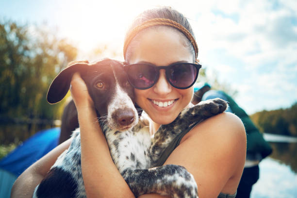Shot of a young woman out camping with her dog