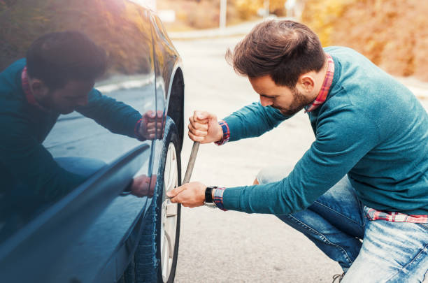 istock Problem with a car. A broken car on the road. Changing wheel 670390636