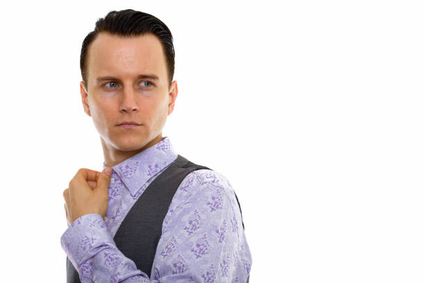 Businessman looking to his flying necktie (isolated on gray)