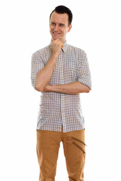 istock Studio shot of young happy man smiling and standing while thinking 670394038