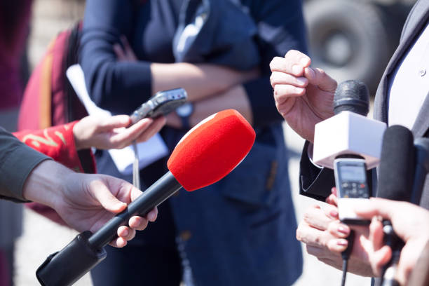 istock Media interview. Broadcast journalism. News conference. Microphones. 670394402
