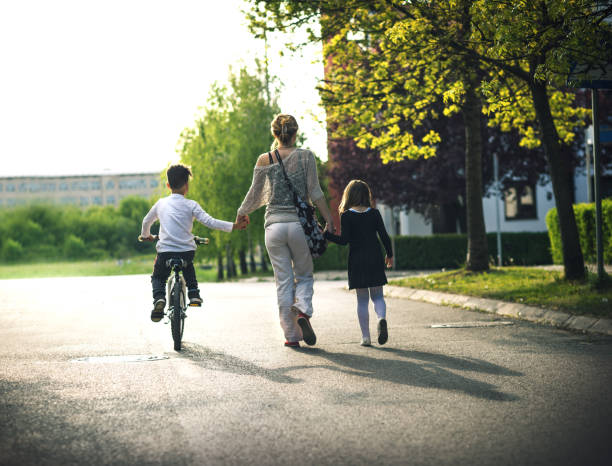 istock mother helping son ride bycicle 670397732