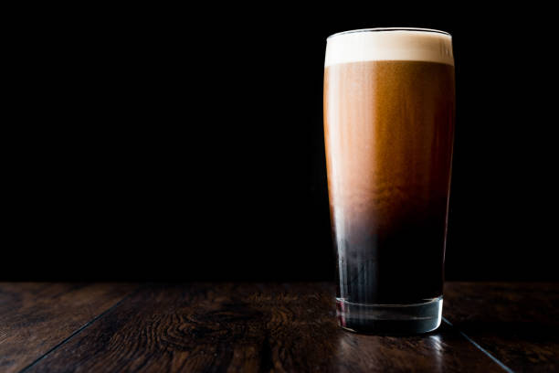 Dark beer on wooden surface. copy space. Dark beer on wooden surface. copy space. Beverage Concept. porter photos stock pictures, royalty-free photos & images