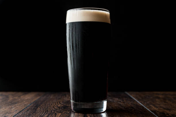 istock Dark beer on wooden surface. copy space. 670398712