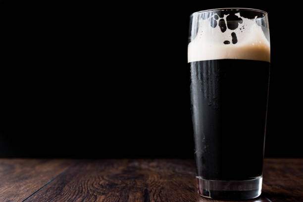 istock Dark beer on wooden surface. copy space. 670400952
