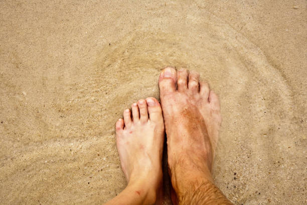 istock feet on the beautiful sandy beach 670401362