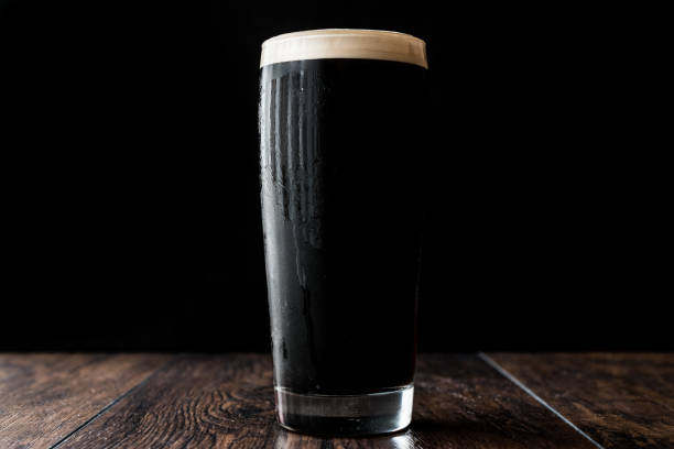 istock Dark beer on wooden surface. copy space. 670401442