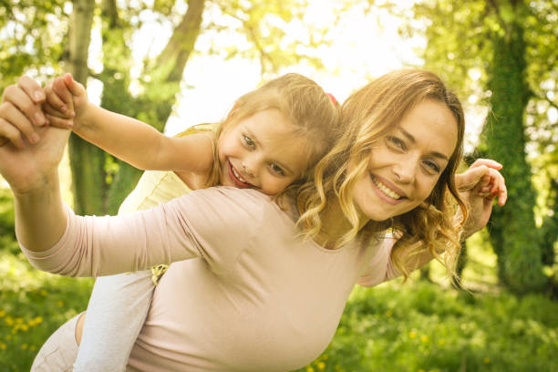 istock Mother and daughter outdoors in a meadow. 670403452