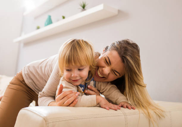 istock Happy mother enjoying while spending time with her son at home. 670405750