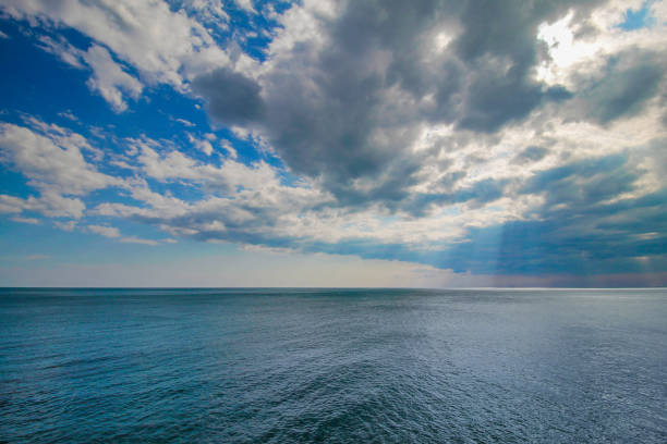 istock Tranquil ocean water and blue cloudy sky. 670405838