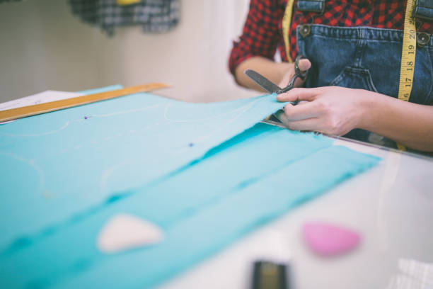 istock Tailor. Woman Hands notch tailor tailor's scissors cloth. 670406956