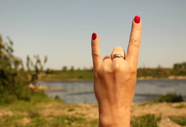istock Woman hand showing rock sign 670407308