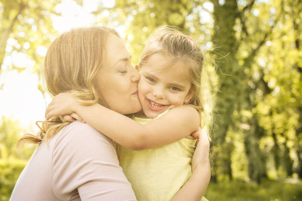 istock Mother and daughter outdoors in a meadow. 670407386