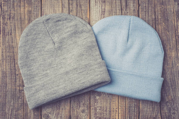 istock Winter caps on an old wooden table. 670407818