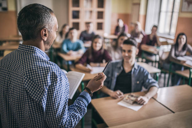 istock High school teacher giving a lecture in the classroom. 670413170
