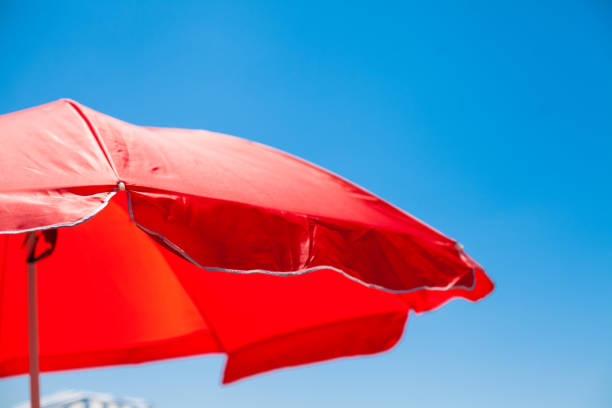 istock Red Parasol Against the Sky 670414396