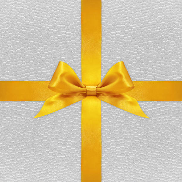 istock Shiny golden satin ribbon bow on silver background 670414486