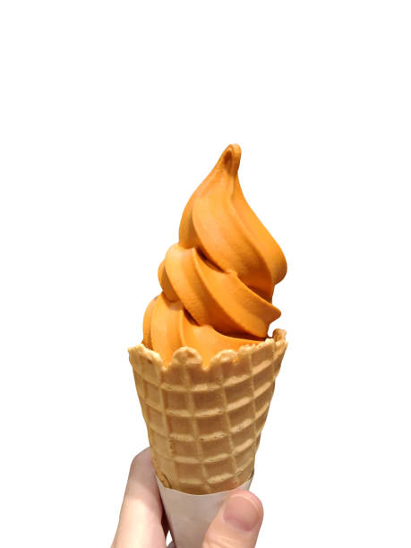 Hand holding Thai tea soft serve ice cream