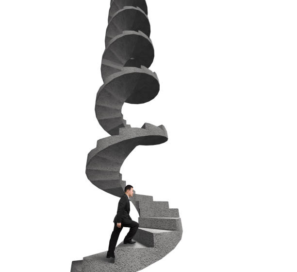 istock Businessman climbing concrete spiral staircase 670417512