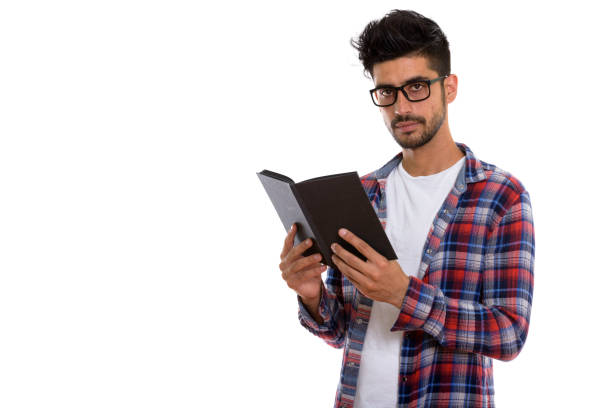 istock Studio shot of young Persian man wearing eyeglasses while holding book 670417756