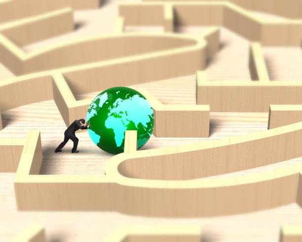 istock Man pushing globe in wooden maze game 670417808