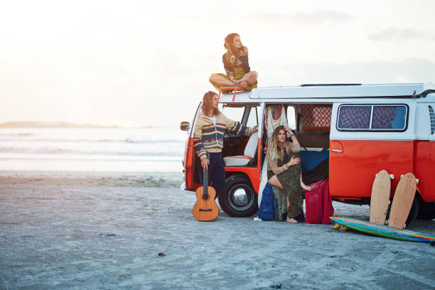 Shot of a group of young friends stopping at the beach during a roadtrip