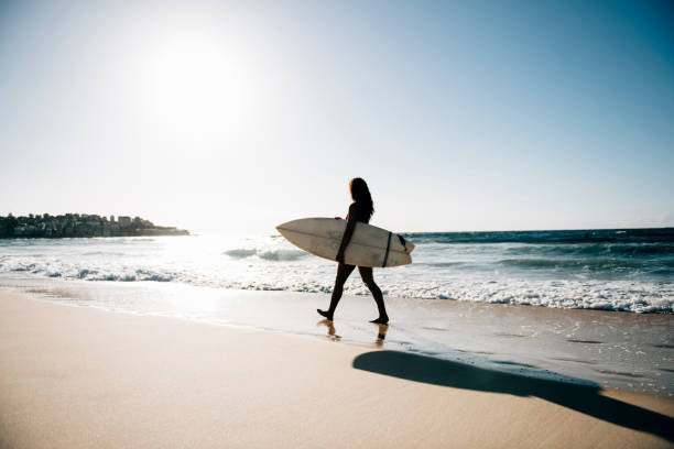 istock Girl surfer walking 670422604