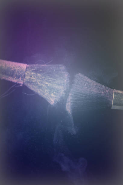 istock Make up brush with purple dust on black background 670425478