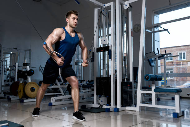 istock Man is exercising on a training machine in the gym 670429572