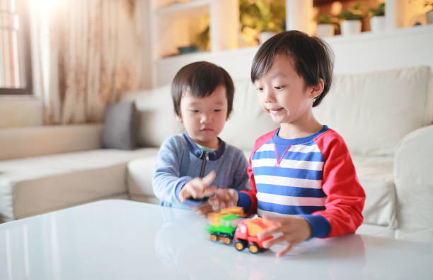 istock Cute Asian children and toy car 670432928