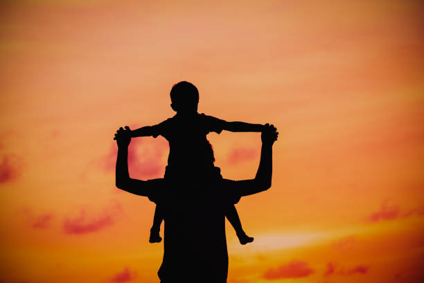 istock father and son having fun at sunset 670433222