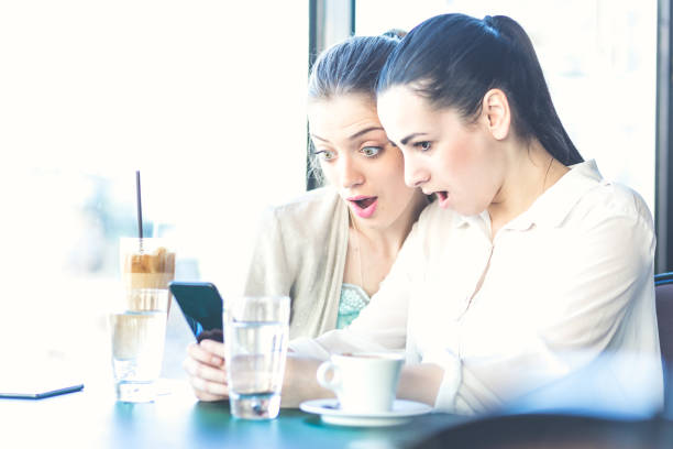 istock Girlfriends, on a coffee break , browsing mobile phone, chating, taking selfies. Belgrade, Serbia, Europe 670433376