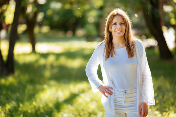 istock Beautiful brunette posing and smiling in nature 670433700